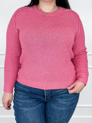 Pink crewneck knit long-sleeve sweater with ribbed cuffs and hem