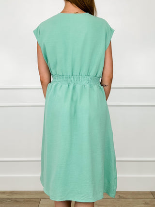 Mint green back view midi dress with elastic waist and short cap sleeves