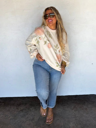 Cream long-sleeve pullover top with leafy floral pattern