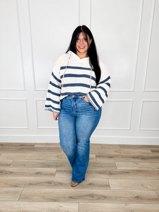 Tummy control flare jeans in medium wash denim with smooth, non-distressed legs