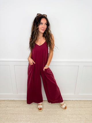 Burgundy sleeveless maxi dress with side pockets and draped hem