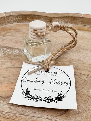 Glass scent diffuser bottle with wooden stopper and rope cord, label: Cowboy Kisses