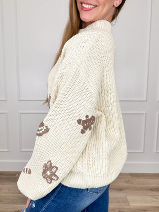 Cream knit mock-neck cropped sweater with gingerbread cookie print, long sleeves
