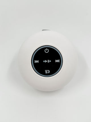 White round Bluetooth speaker with top control icons and power button