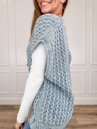 Light blue cotton knit sweater vest, sleeveless side view with textured cable pattern