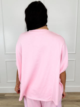 Pink short-sleeve cotton blend top, back view with relaxed shoulder fit