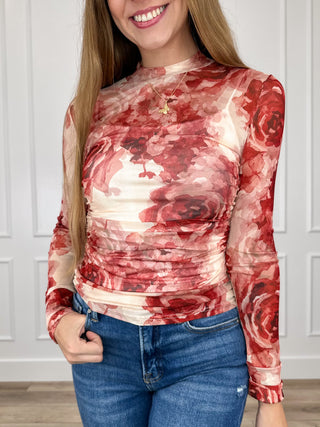 Sheer mesh long-sleeve top with red floral print over cream, ruched waist