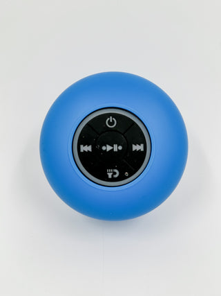 Blue round Bluetooth speaker with top control icons and power button