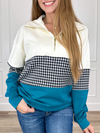 Long-sleeve quarter-zip top in cream with black/white gingham and teal-blue color-block sleeves