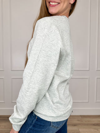 Grey long-sleeve crewneck sweatshirt, side view, relaxed fit