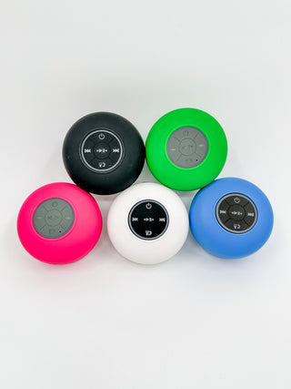 Black round Bluetooth speaker with top control icons and power button