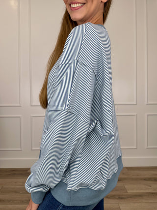 Blue and white striped long-sleeve sweatshirt, cuffed sleeves, side profile