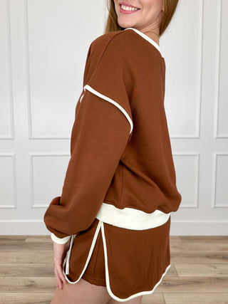 Brown long-sleeve top and matching drawstring shorts set, side view, white trim