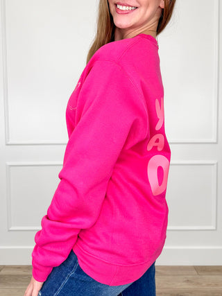 Pink crewneck sweatshirt with large graphic text detail along the sleeve side.
