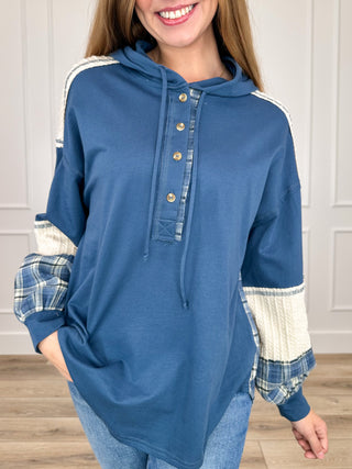 Blue cotton hooded long-sleeve top with plaid accent cuffs and button placket