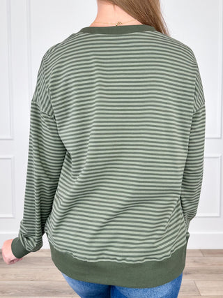 Green striped long-sleeve top, back view, rounded neckline and banded cuffs