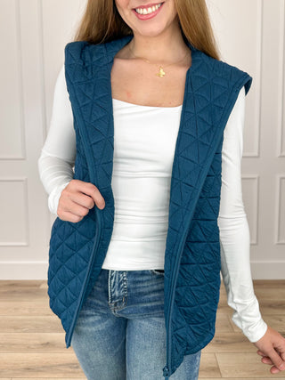 Blue quilted hooded vest with diamond pattern, sleeveless design