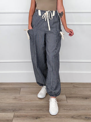 High-rise knit striped pants with elastic waist and drawstring, navy pinstripe