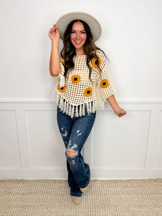 Sunflower crochet fringe top and blue ripped jeans with beige hat
