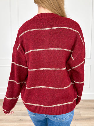 Wine red knit cardigan with cream striped back yoke and long sleeves, button closure