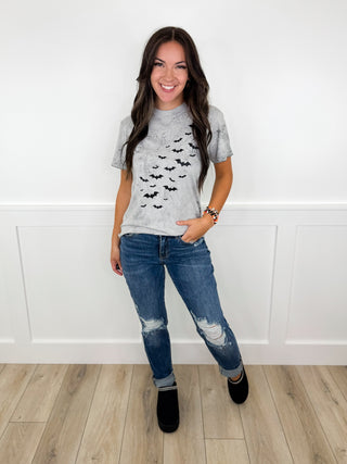 Casual outfit with gray cat-print T-shirt, blue jeans, and black ankle boots