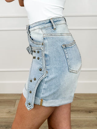 Light wash denim high-rise shorts with side pocket and stud-trim draped panel.