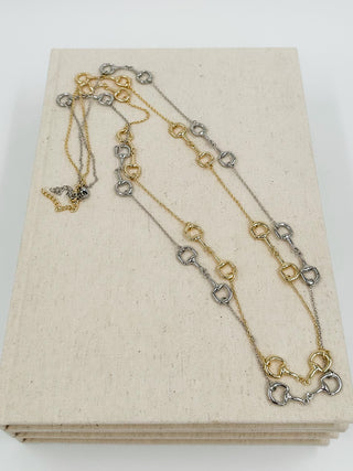 Two-tone layered chain necklace with small dangling charms and lobster clasp