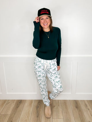 Two-piece outfit set with dark green long-sleeve top and light patterned pants