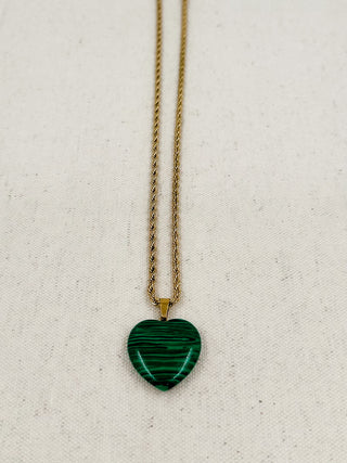 Gold heart pendant necklace with green heart charm