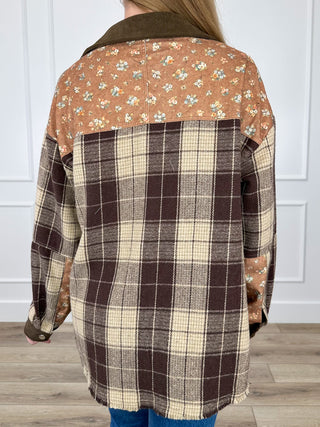 Back view of brown plaid button-up shacket with floral upper yoke and pocket detail