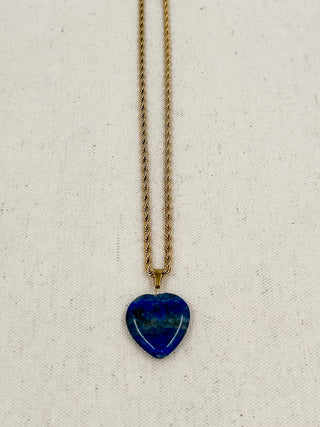 Gold heart pendant necklace with dark blue heart charm