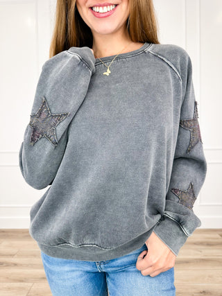 Grey long-sleeve crewneck sweatshirt with distressed star patches on both sleeves