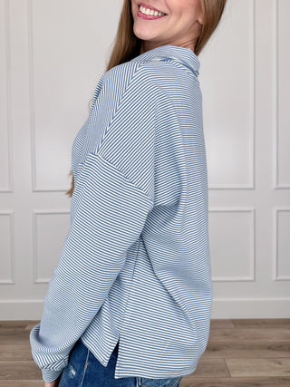 Blue-and-white striped long-sleeve half-zip sweatshirt, side view, ribbed cuffs