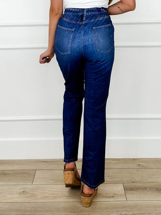 High-rise dark wash denim jeans with front pockets, seam details, and wide leg