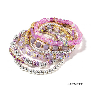 Garnett pink beaded bracelet stack with gold-tone accents and sparkly rhinestone layers
