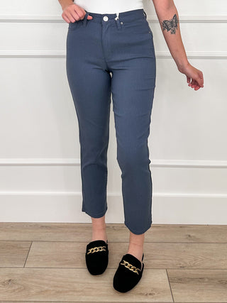 High-rise straight leg pants in blue with belt loops and button-front design