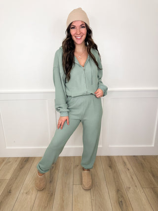 Sage green lounge set with half-zip top and matching jogger pants