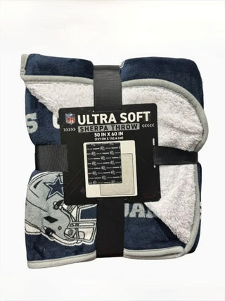 Sherpa throw blanket, navy blue with NFL Ultra Soft Sherpa Throw label and black straps