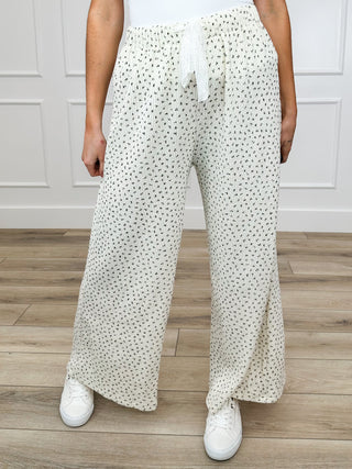 High-rise cotton-blend bottoms in cream with allover small dot print, tie front.