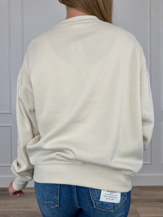 Cream crewneck long-sleeve sweatshirt shown from the back