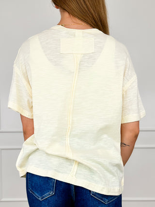 Cream cotton short-sleeve top, back view with vertical yoke seam