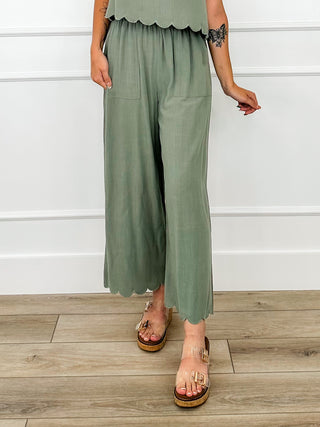 Green high-rise wide-leg bottoms with gathered waist and scalloped hem
