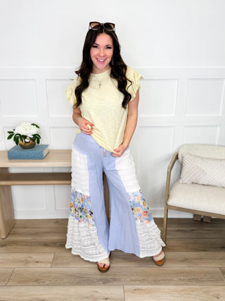 Yellow short-sleeve blouse with scalloped sleeves and light blue wide-leg lace trousers