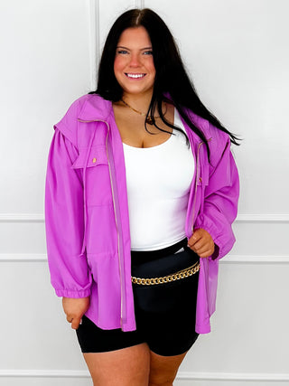 White cropped tank top with thick straps under purple jacket