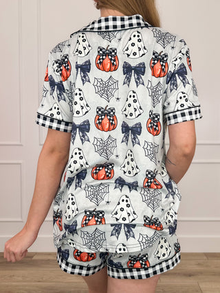 Pumpkin-print pajama set back view with short-sleeve button-up top and elastic waist shorts