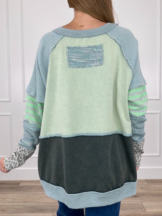 Cotton blend long sleeve top, back view, rectangular patch pocket detail, blue and light panels