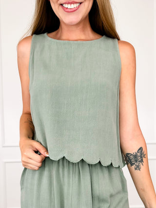 Green sleeveless cropped tank top with scalloped edge hem and loose fit