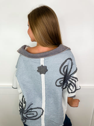 Blue cotton-blend short-sleeve top, back view with butterfly embroidery
