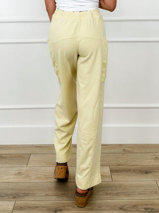 High-rise cotton blend pants, light yellow with drawstring waist and cargo pocket seams