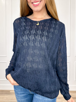 Navy blue knit long-sleeve top with textured pattern and rounded neckline